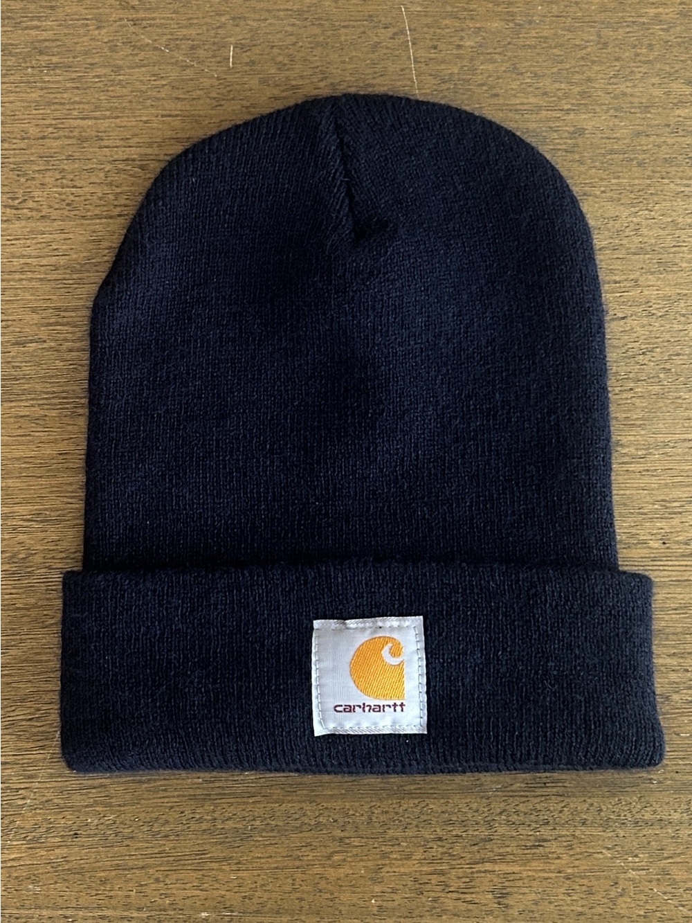 Carhartt Men’s Dark Navy Blue Cuffed Beanie with Gold Logo Patch.